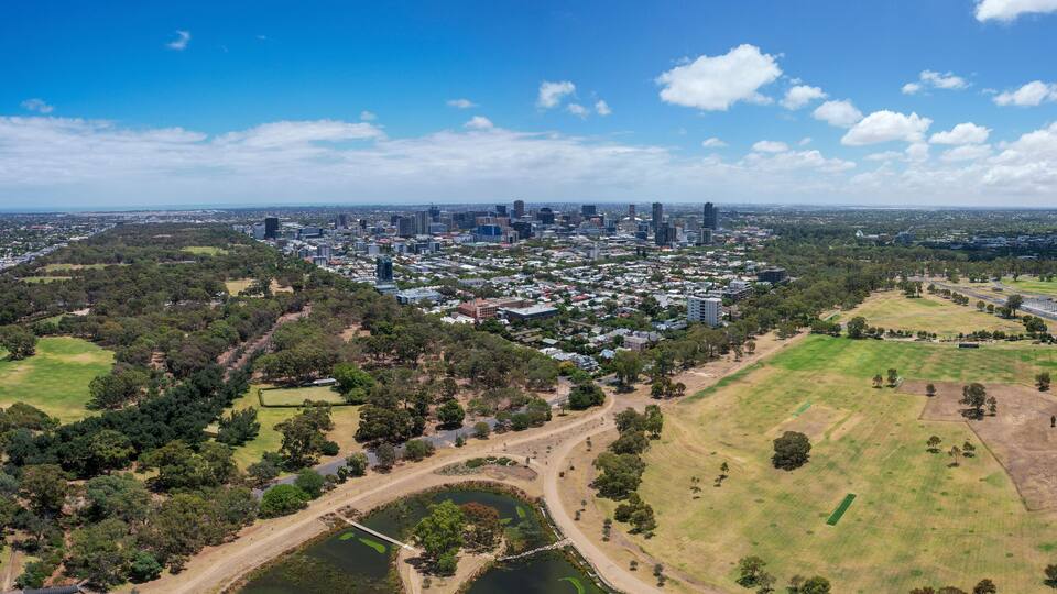 Aerial view of victoria park wetlands and sports fields with greenery and buildings, adelaide, australia.