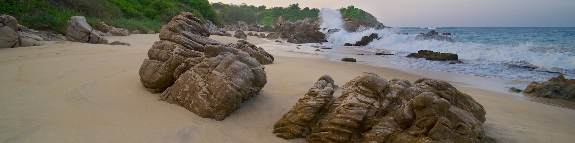 Bacocho Beach which includes landscape views, rocky coastline and a sandy beach