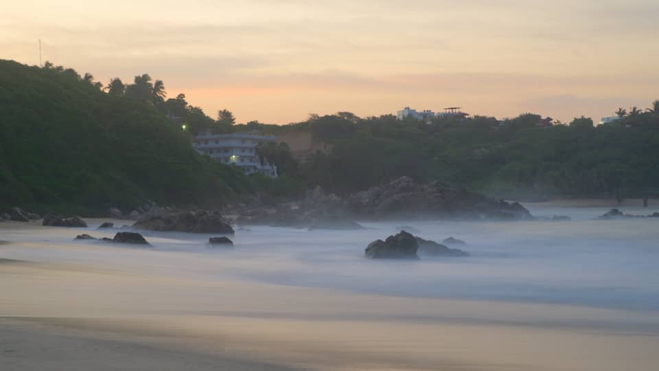 Bacocho Beach featuring a sunset, rocky coastline and a beach