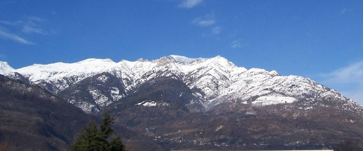 A snow-covered mountain range with clear blue skies.