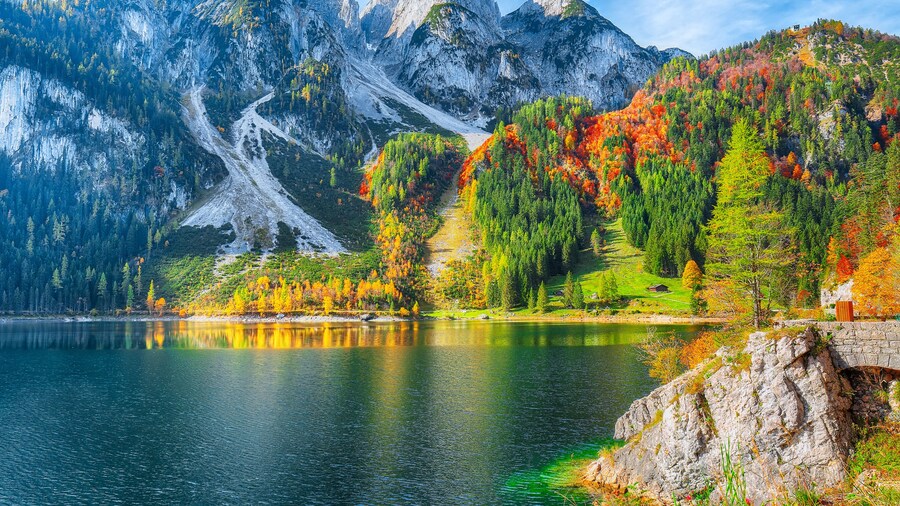 autumn scenery with Dachstein mountain summit reflecting in crystal clear Gosausee mountain lake