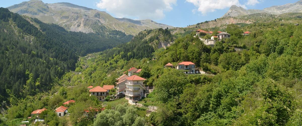 A mountainous landscape with houses on a hillside.