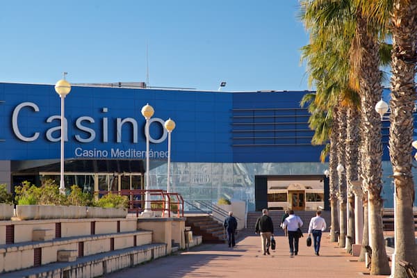 Casino Mediterraneo showing signage as well as a small group of people