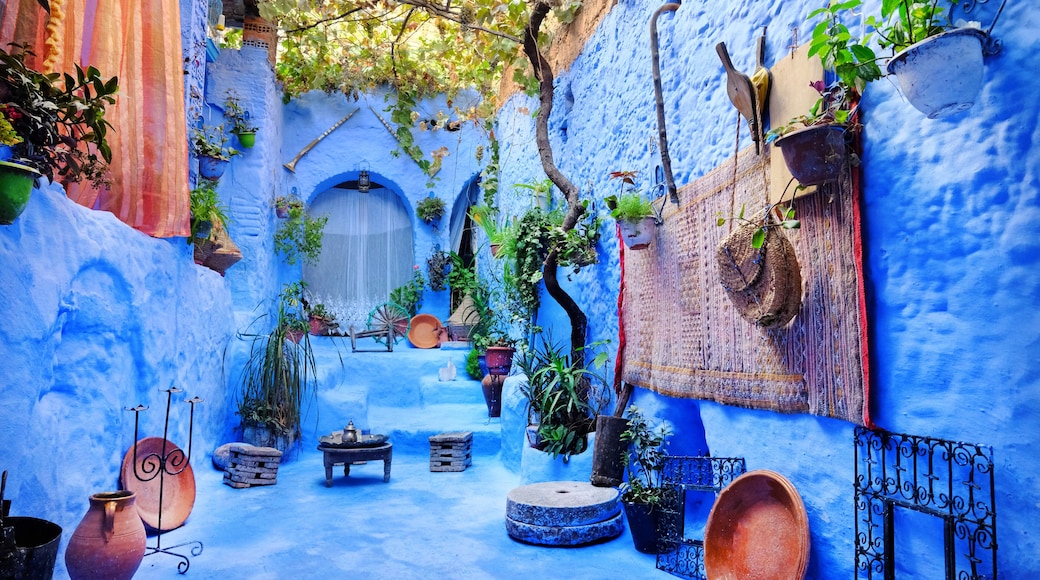 Cozy patio inside a blue house in medina of the blue city Chefchaouen, Morocco. Traditional moroccan architectural details.