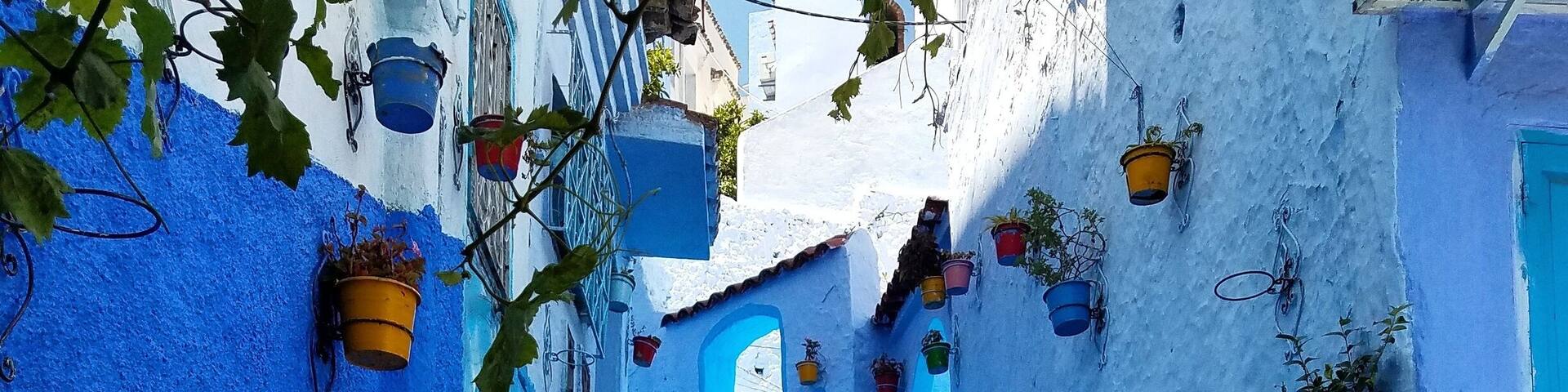 A blue-painted staircase leading up to a building with a blue door.