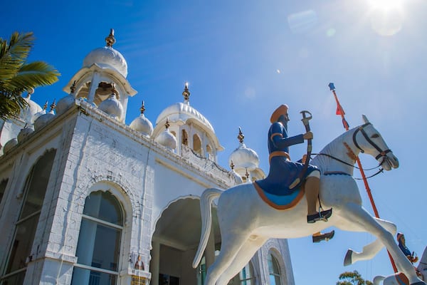 Guru Nanak Sikh Temple showing a sunset, a mosque and a temple or place of worship