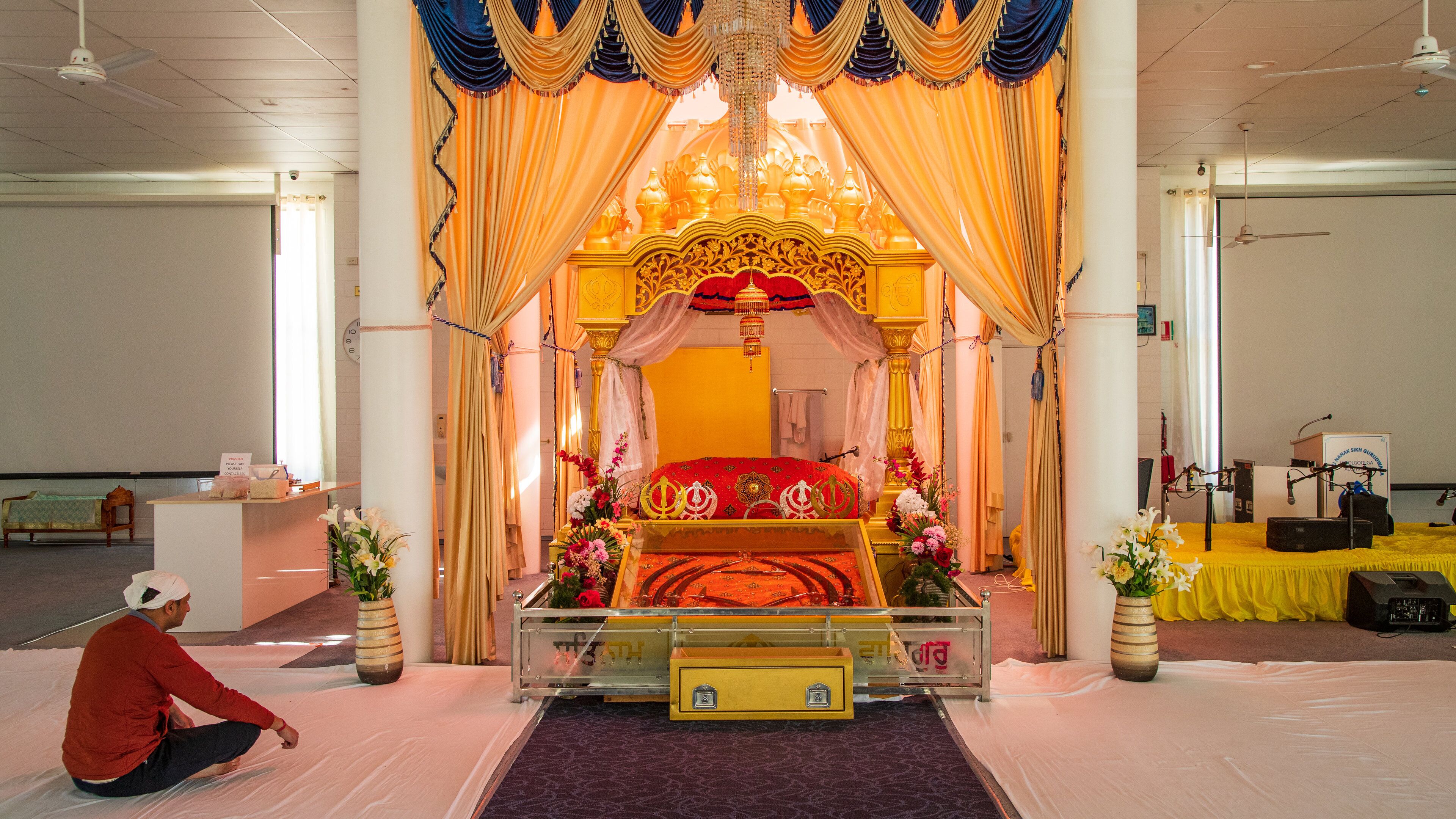 Guru Nanak Sikh Temple which includes interior views and a temple or place of worship as well as an individual male