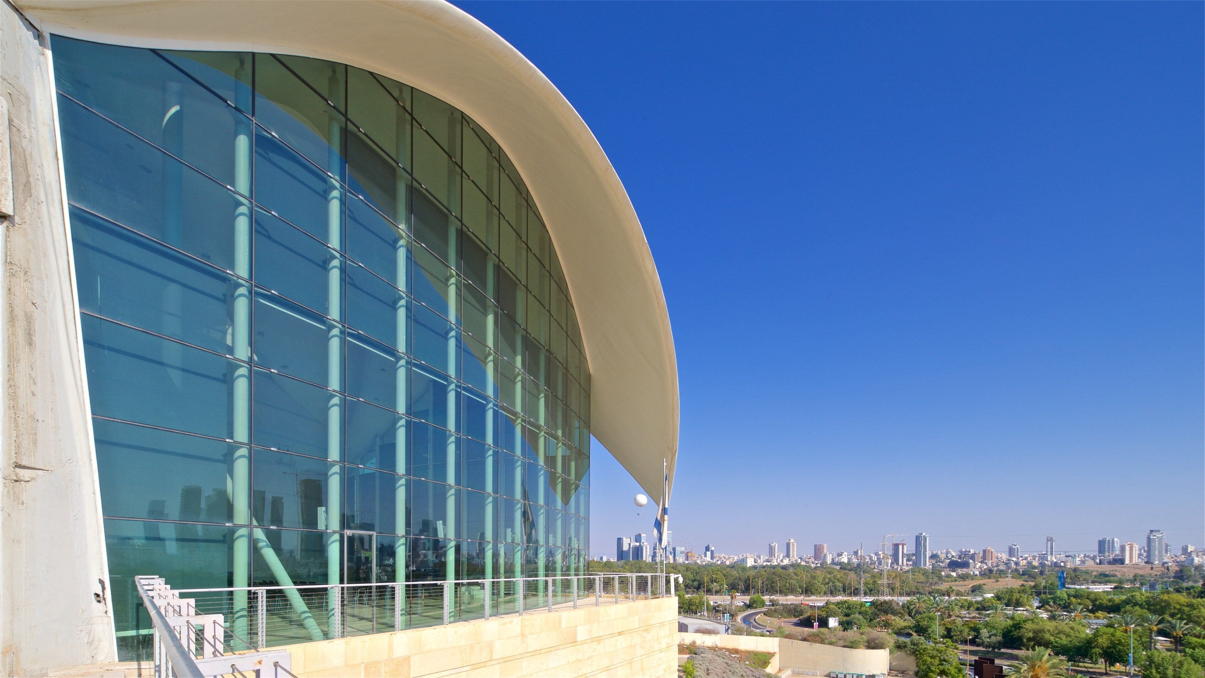 A modern building with a curved facade and large glass windows.