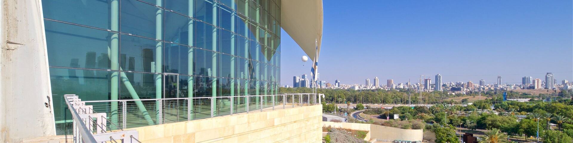 A modern building with a curved facade and large glass windows.