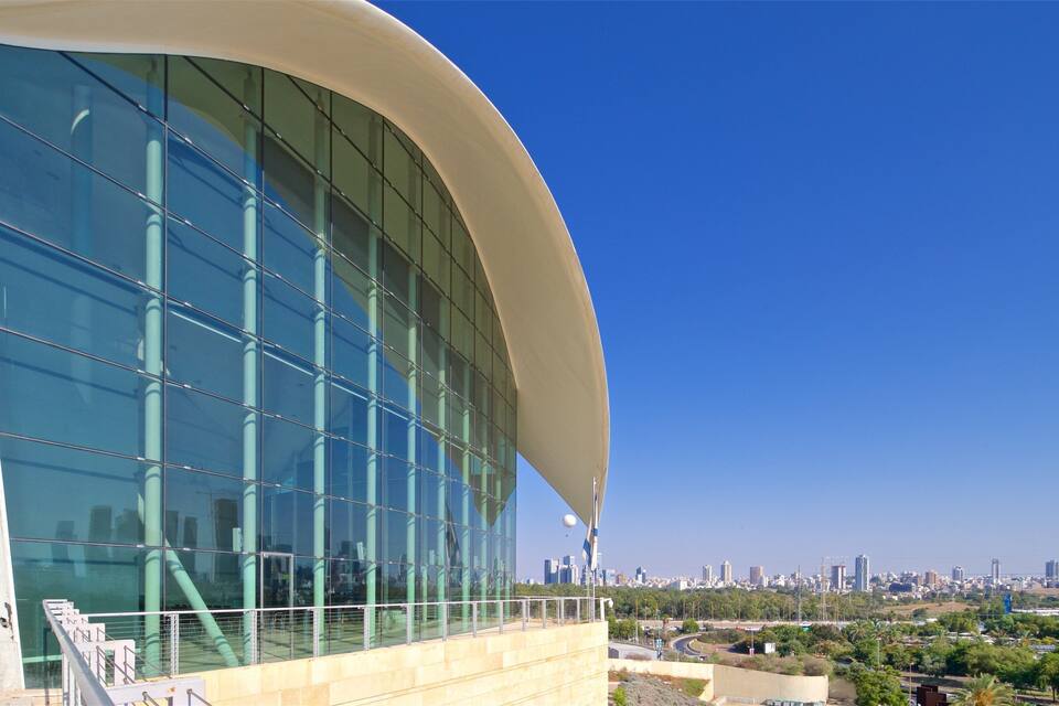 A modern building with a curved facade and large glass windows.
