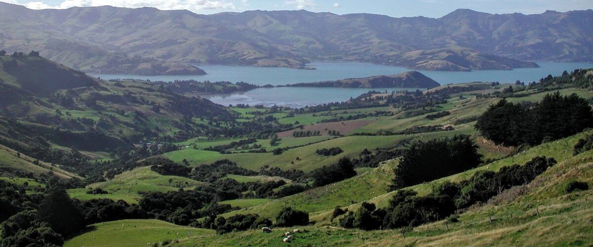 Rolling hills, a lake, and distant mountains.