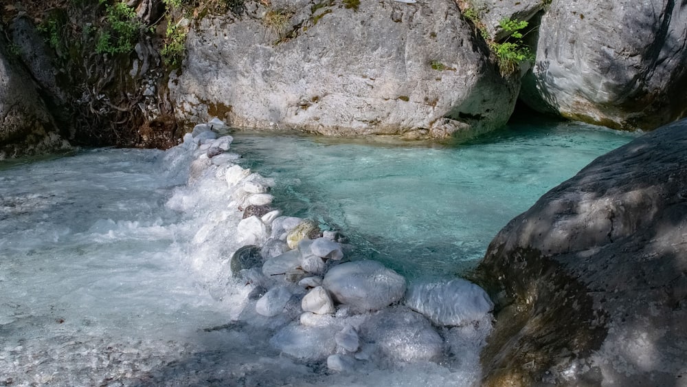 Little stone dam in the blue clear river in Pozar, Greece