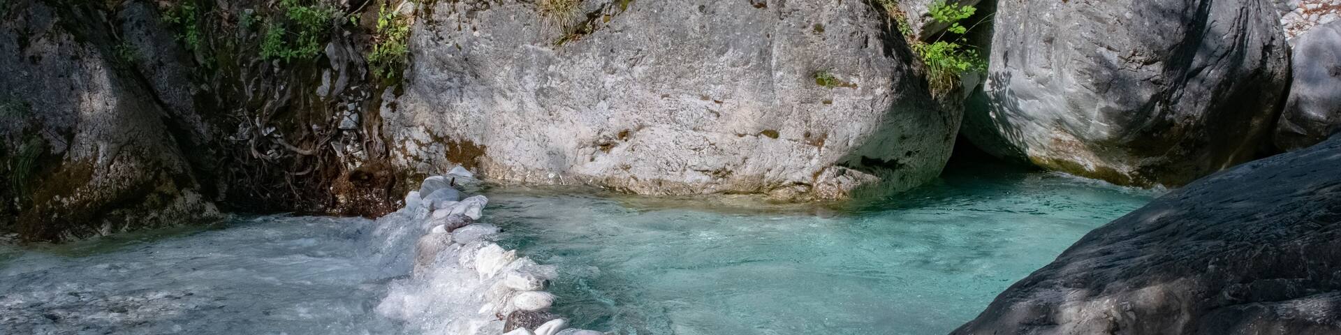 Little stone dam in the blue clear river in Pozar, Greece