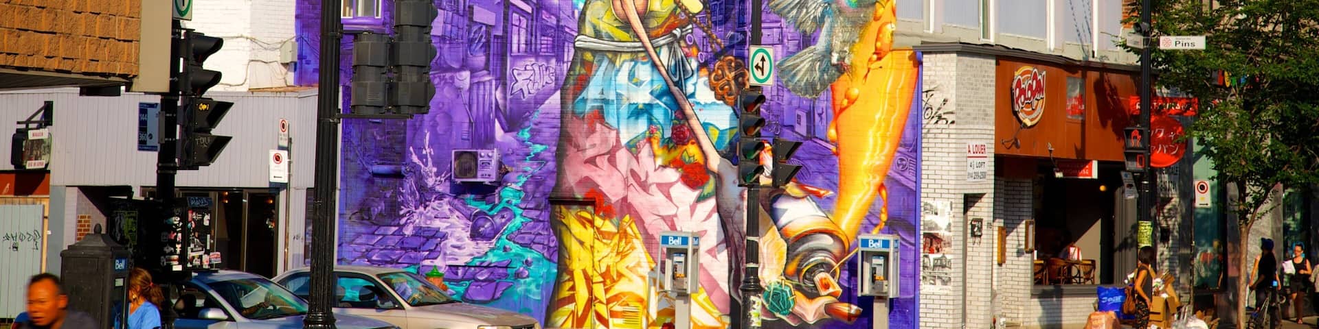 A vibrant mural on a building with a large bird, a woman, and a cityscape.