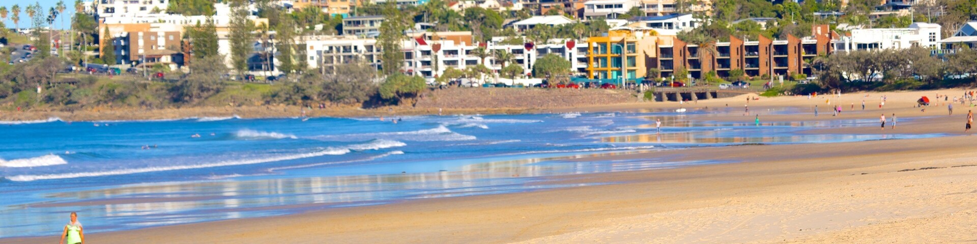 Alex Beach which includes a sandy beach as well as a small group of people