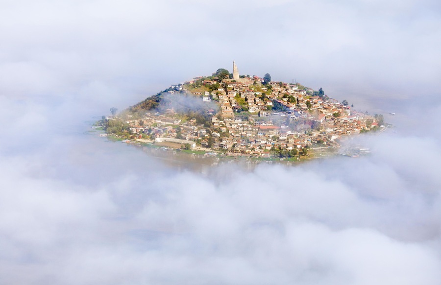 Aerial view of the island of Janitzio surrounded by clouds in Lake Patzcuaro, Michoacan, Mexico.
