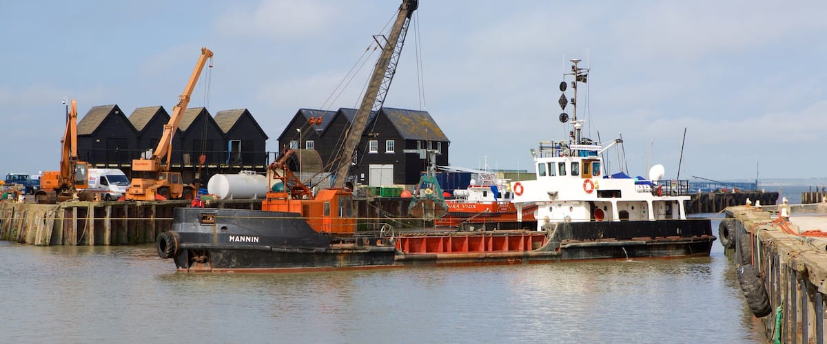 Whitstable Harbour featuring industrial elements and a marina
