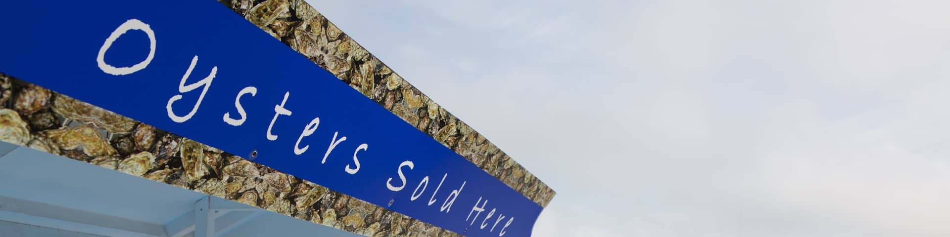 Whitstable Harbour featuring outdoor eating and signage
