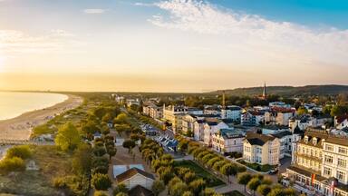 A coastal town with a pier, beach, and historic buildings.