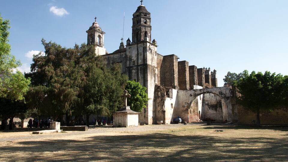An old church with a bell tower and a large arched entrance.