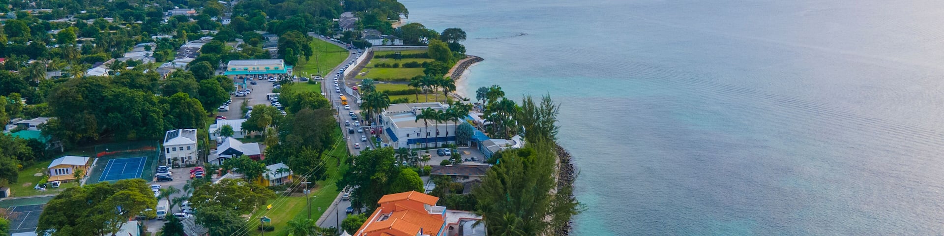 A coastal resort with a swimming pool, beachfront, and a view of the ocean.