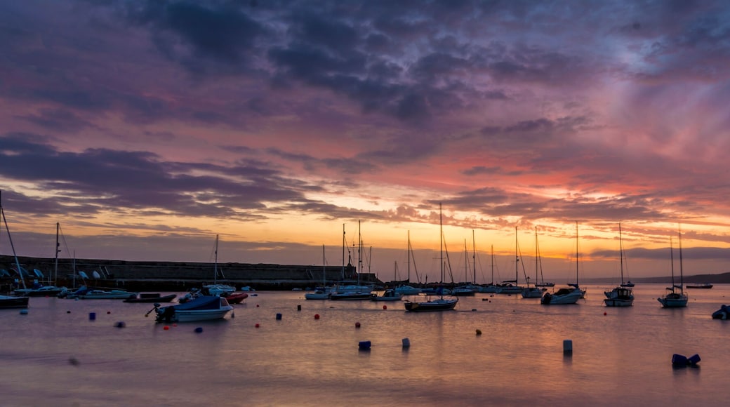 Dawn breaking over a harbour with small boats and yachts