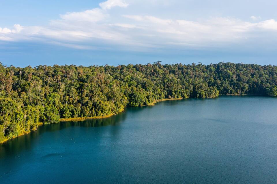 A large lake surrounded by dense forest.