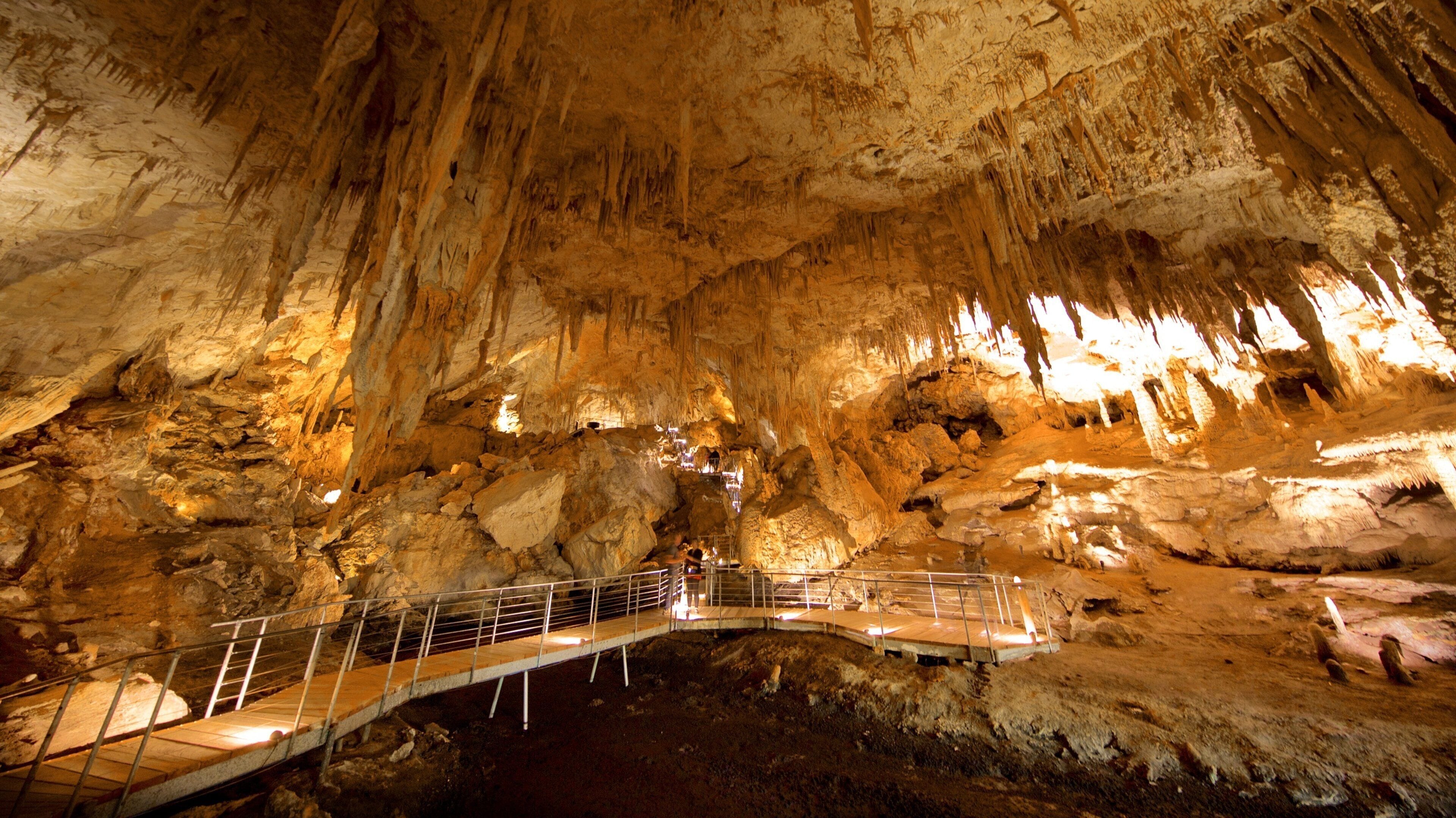 Una cueva con estalactitas y un sendero.