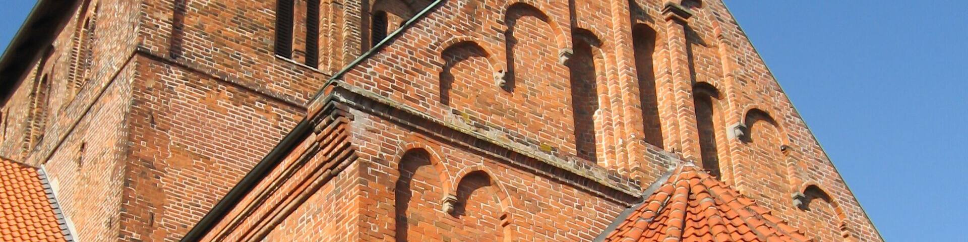 Looking up at the belltower of the 13’th century brick church at the cannon monastery in the German Town of Bassum on a clear sunny day.