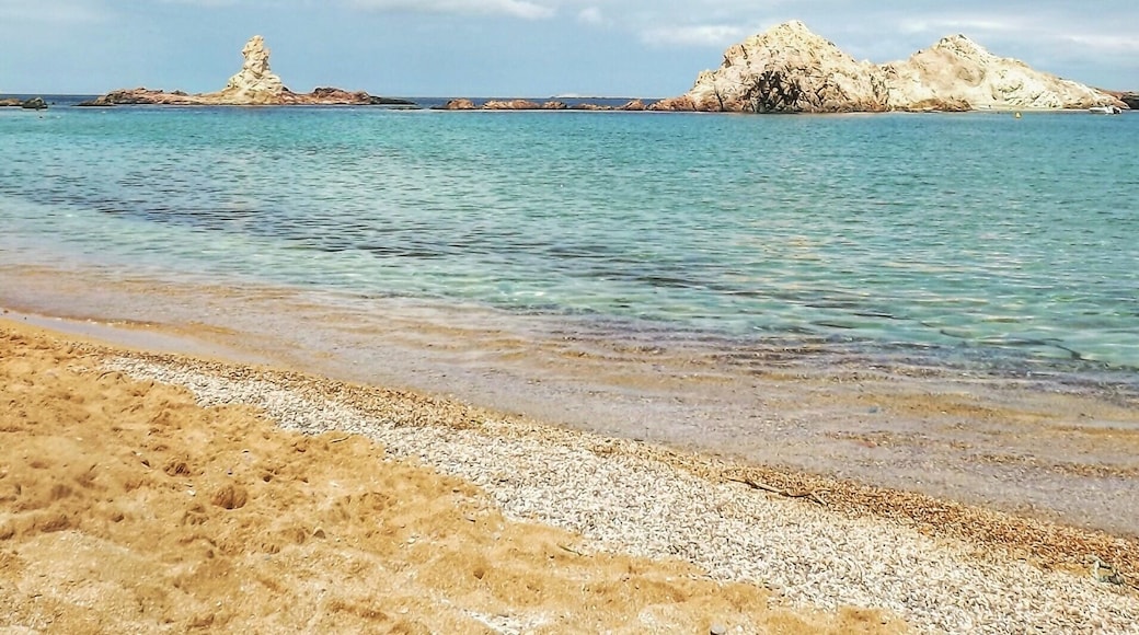 Cala Pregonda in Menorca island (Spain). A perfect place to admire the combination of orange, blue and white colors.