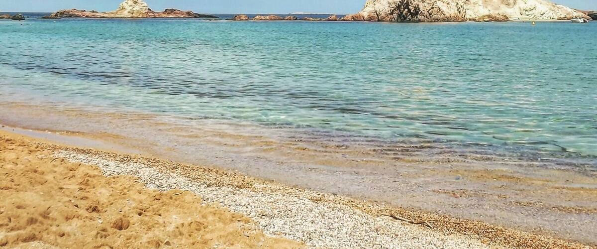 Cala Pregonda in Menorca island (Spain). A perfect place to admire the combination of orange, blue and white colors.