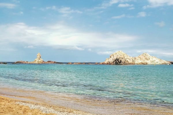 Cala Pregonda in Menorca island (Spain). A perfect place to admire the combination of orange, blue and white colors.