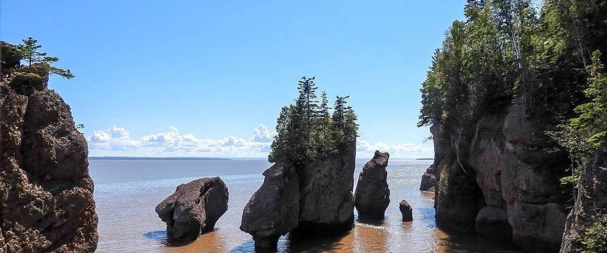 The Hopewell Rocks, which stand 40-70 feet tall, also called the Flowerpots Rocks or simply The Rocks, are rock formations caused by tidal erosion in The Hopewell Rocks Ocean Tidal Exploration Site in New Brunswick. To truly appreciate the height and range of the highest tides in the world, visit the the place during both high tide and low tide. (September 2017)