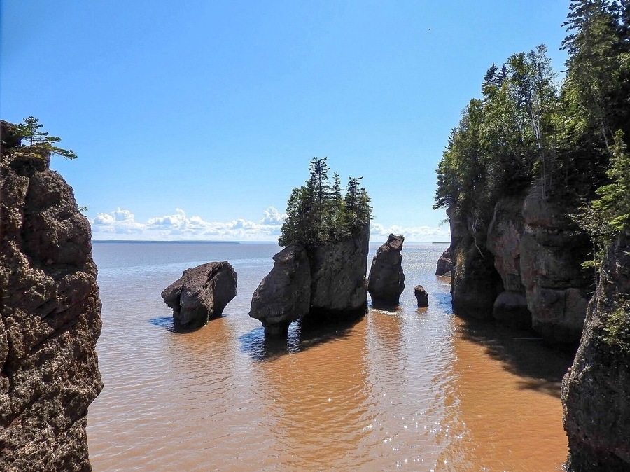 The Hopewell Rocks, which stand 40-70 feet tall, also called the Flowerpots Rocks or simply The Rocks, are rock formations caused by tidal erosion in The Hopewell Rocks Ocean Tidal Exploration Site in New Brunswick. To truly appreciate the height and range of the highest tides in the world, visit the the place during both high tide and low tide. (September 2017)