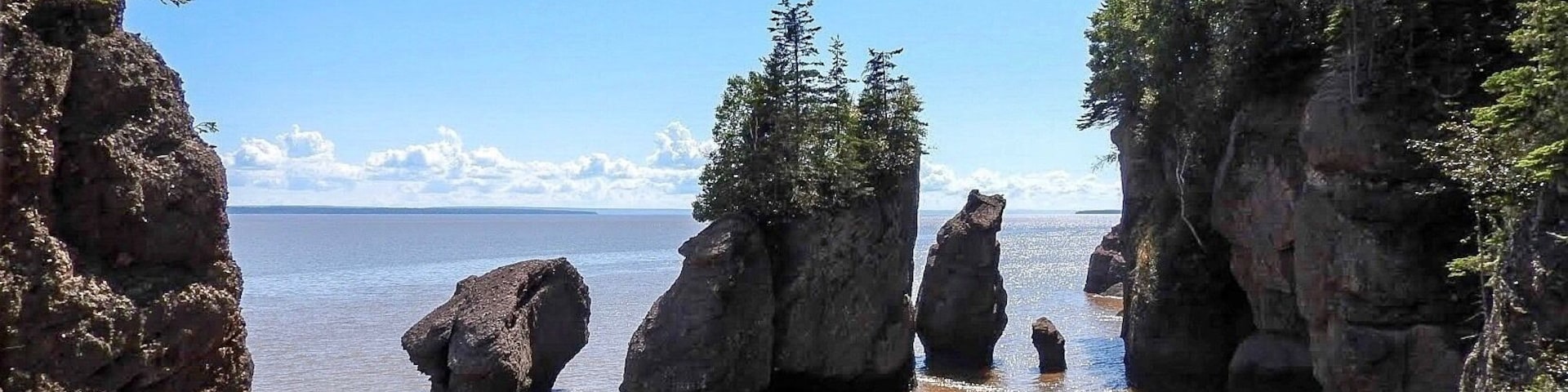 The Hopewell Rocks, which stand 40-70 feet tall, also called the Flowerpots Rocks or simply The Rocks, are rock formations caused by tidal erosion in The Hopewell Rocks Ocean Tidal Exploration Site in New Brunswick. To truly appreciate the height and range of the highest tides in the world, visit the the place during both high tide and low tide. (September 2017)