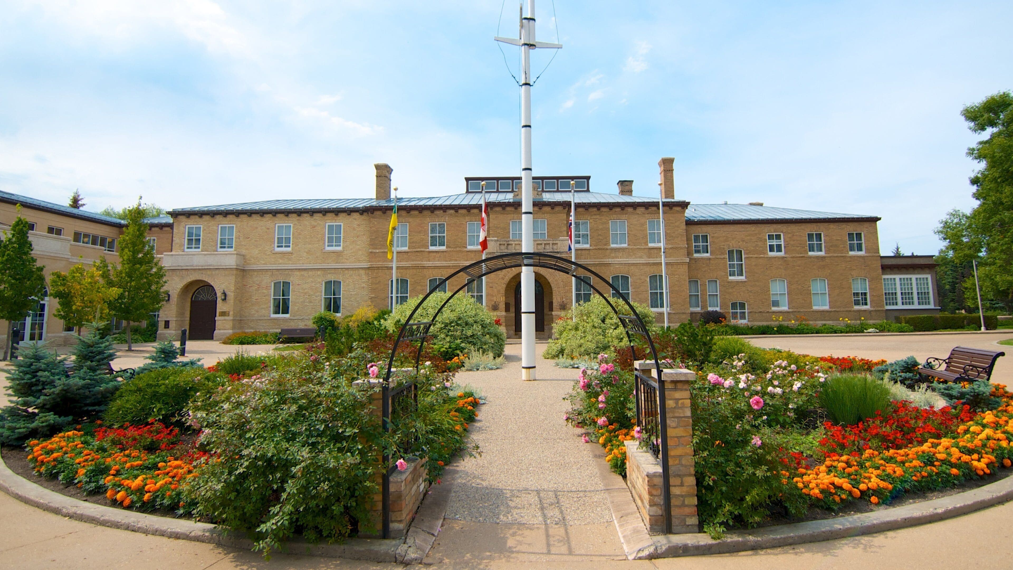 Government House featuring a square or plaza, flowers and heritage architecture