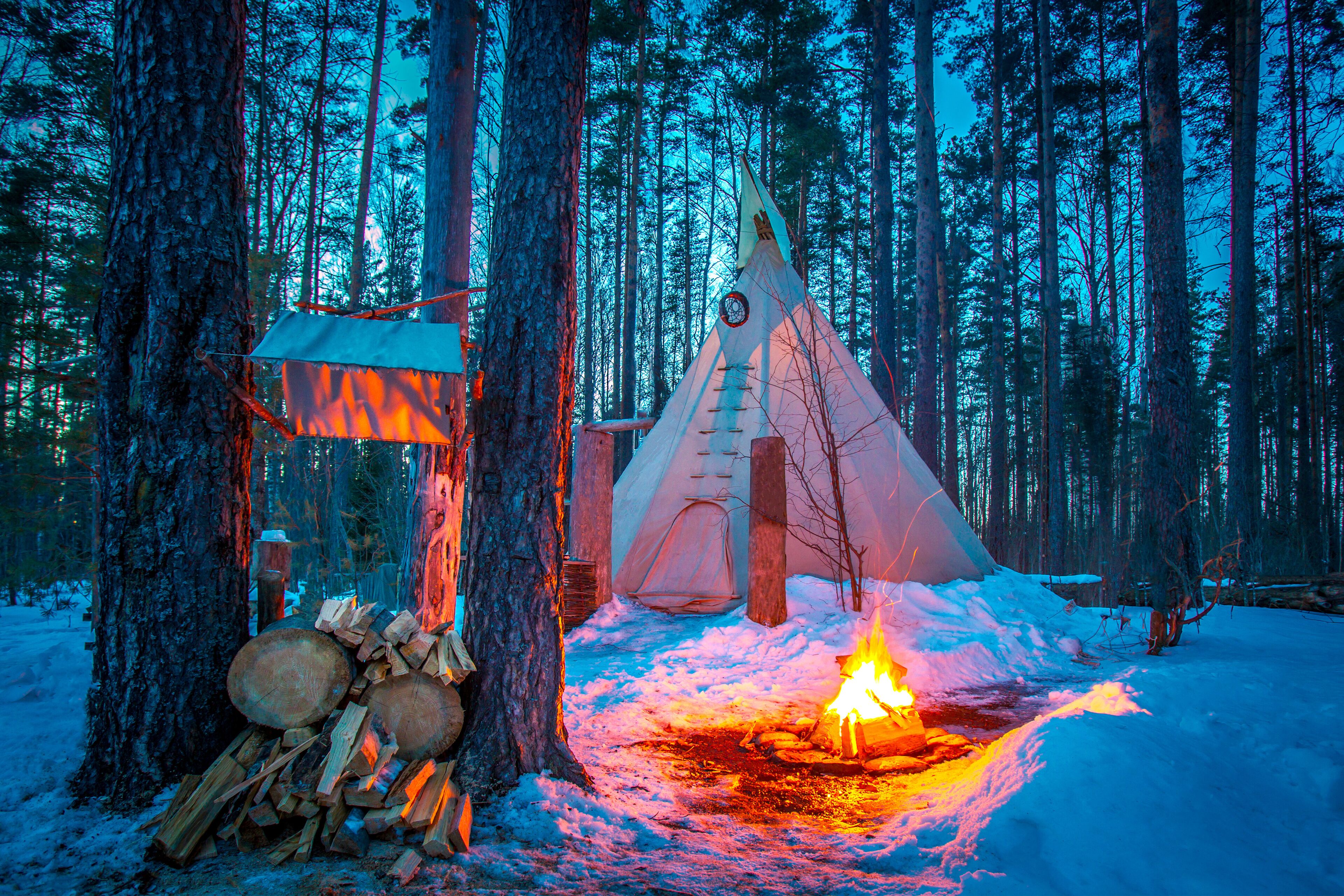 Tipi. Forest in winter. Indian Home. Bonfire in the forest. Ethnography. People of America. Living in the forest. Ecological tourism. Wigwam.