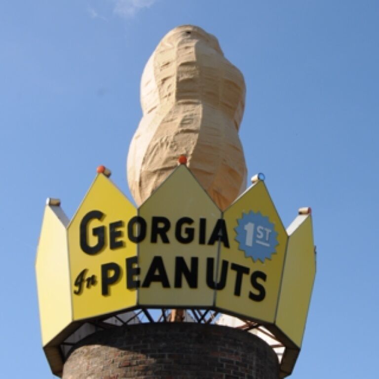 True Roadside Americana - The nut in Ashburn, ten feet in height, atop a fifteen foot high cylindrical brick structure and surrounded by a huge crown proclaiming, "Georgia 1st in Peanuts." 

This lofty legume was erected in 1975. 
and worth the #TroverDetour for an iconic photo or a selfie with the nut in the background.

You can see it from the highway making it a must see on your next #roadtrip through the area.

Located half a mile south of Exit 28 beside the southbound lanes of I-75. To visit, take Exit 28, then drive west and turn left on the first road and left at the service road to the peanut. Appropriately enough, Ashburn also has the world's largest peanut shelling plant.

#TroverDetour