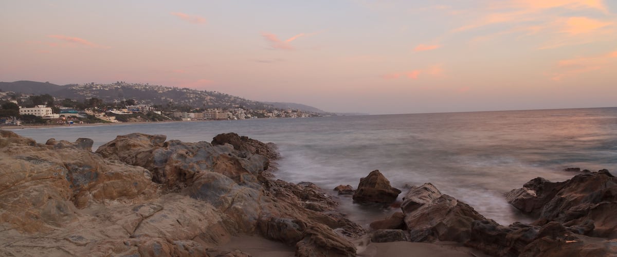 Long exposure of rocks in waves, giving a mist like effect over ocean in Laguna Beach, California