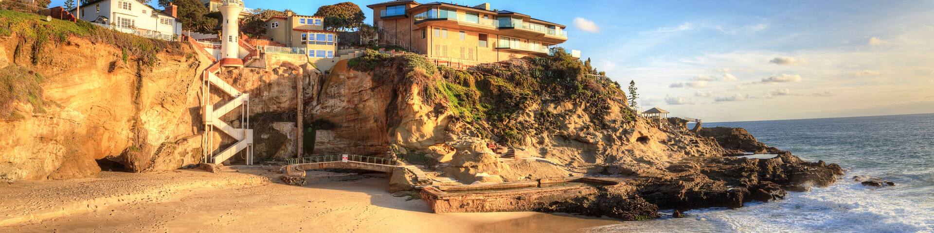 Blue sky over the coastline of One Thousand Steps Beach with tidal pools and cliffs in Laguna Beach, California, USA