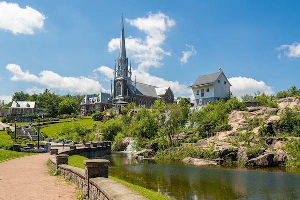 Petite Maison Blanche Museum featuring a garden, a river or creek and a church or cathedral