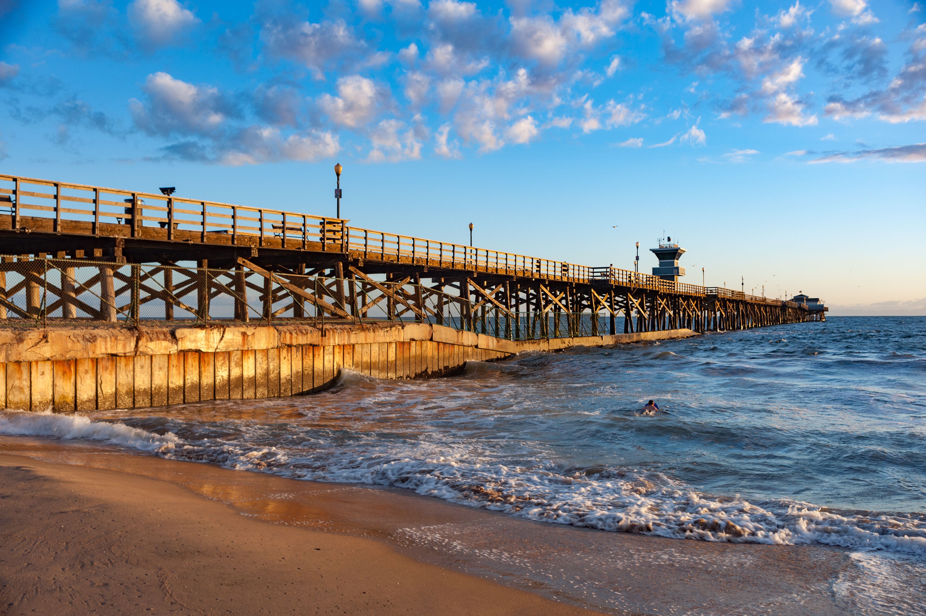 Sunset light hitting seal beach pier in southern California