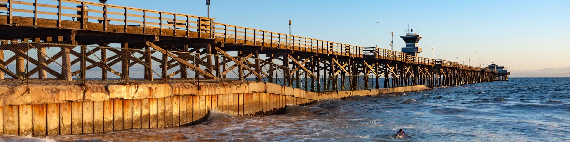Sunset light hitting seal beach pier in southern California