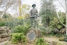 A statue of a man holding a rifle on a rock with a plaque that reads "Cuba" and "United States of America".