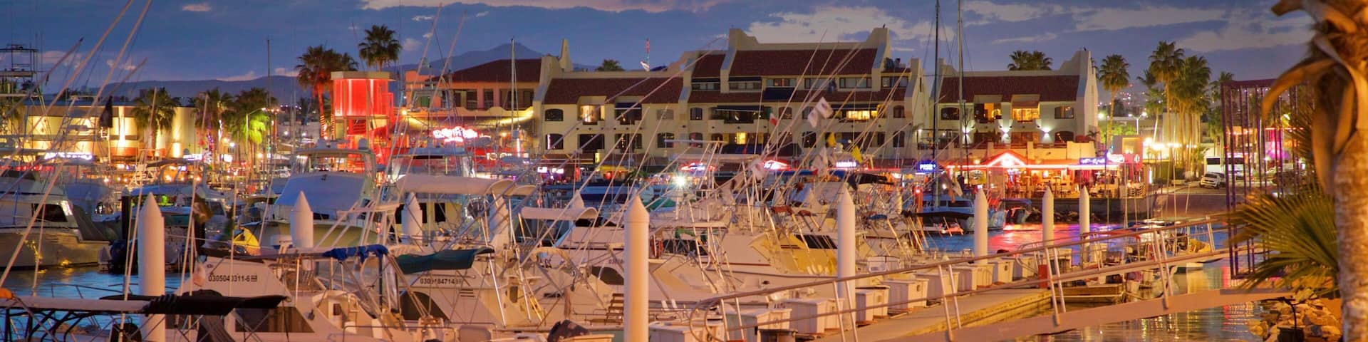 Marina which includes a bay or harbor and a sunset