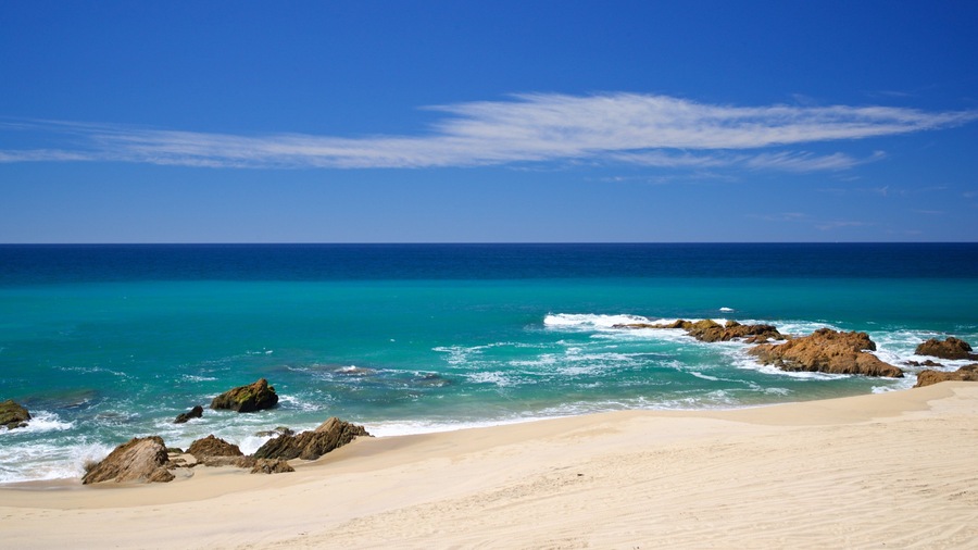 Migrino which includes a sandy beach, rocky coastline and general coastal views