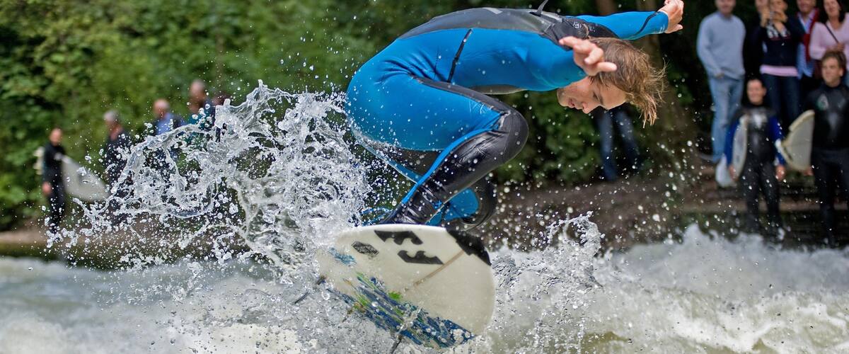 Eisbach Surfing which includes waves and surfing as well as an individual male
