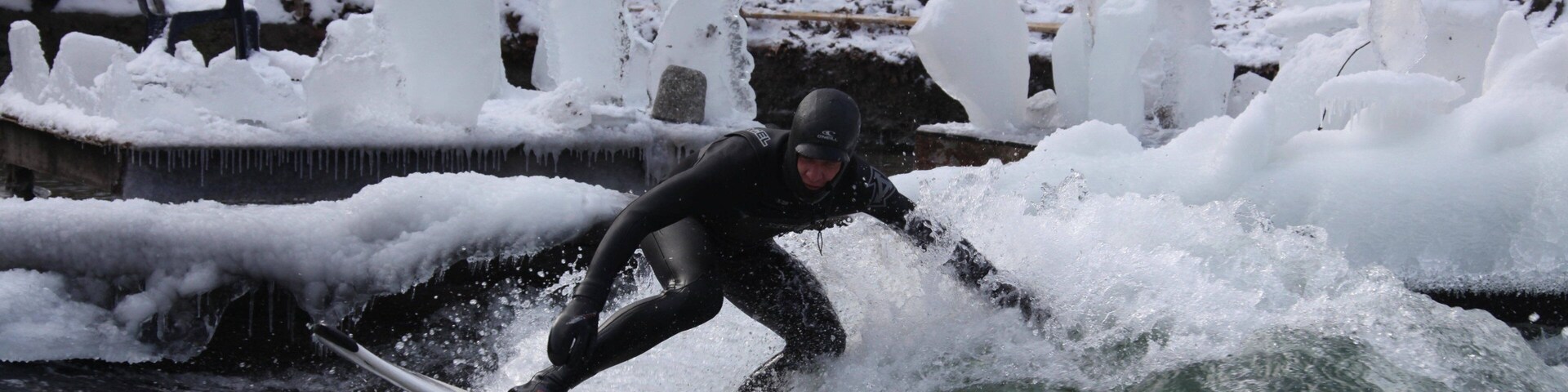 Eisbach Surfing featuring surf and surfing as well as an individual male