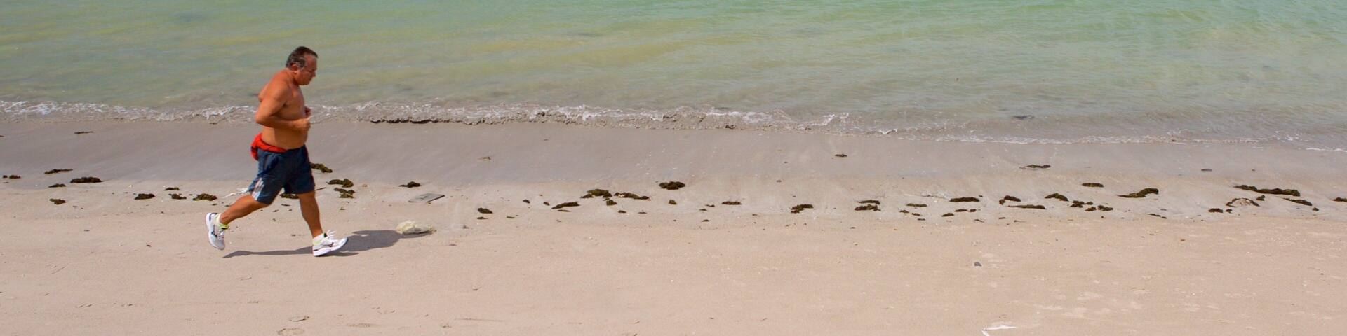 Ponta Verde Beach showing general coastal views and a beach as well as an individual male