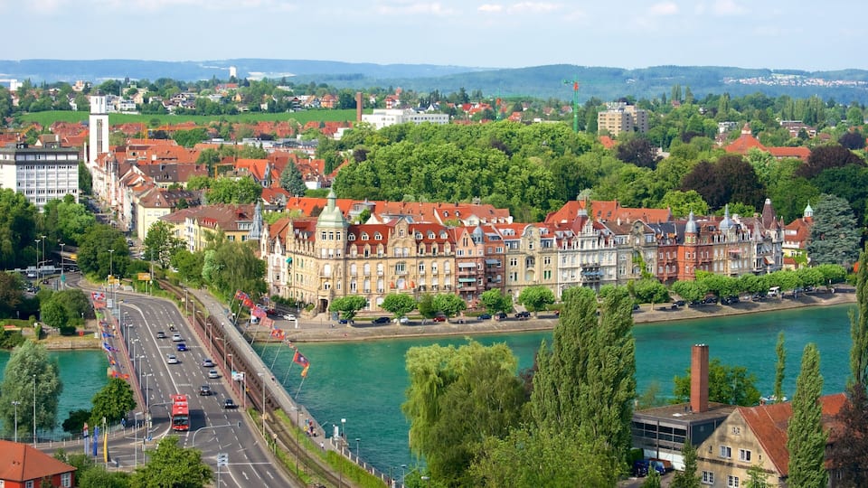 A riverside town with historic buildings, a bridge, and a river.